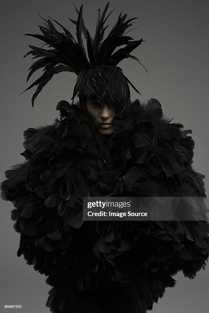 A woman dressed in a feather outfit