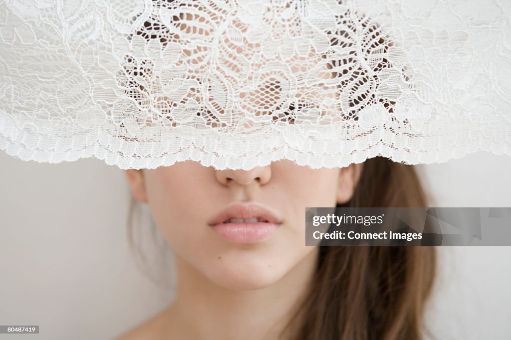 Woman behind a net curtain