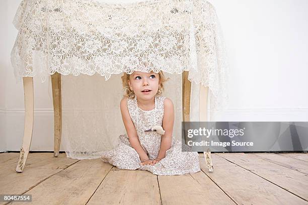 girl hiding under a table - kid hide and seek stock pictures, royalty-free photos & images