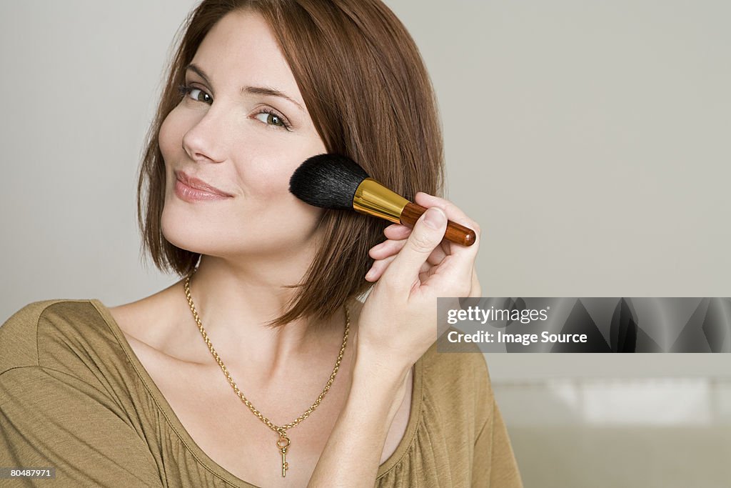Woman applying makeup