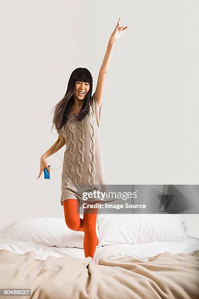 woman dancing on bed - strumpbyxor bildbanksfoton och bilder