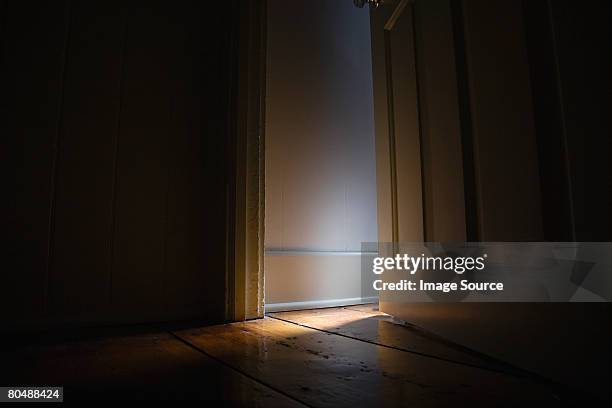 light and dark - door ajar stock pictures, royalty-free photos & images