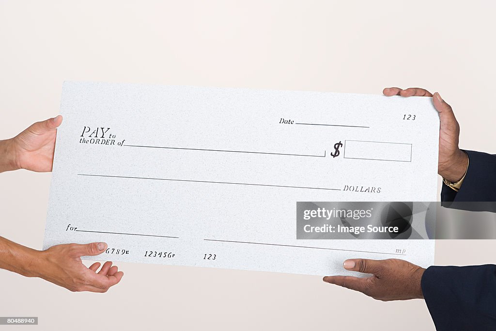 Two people holding a cheque
