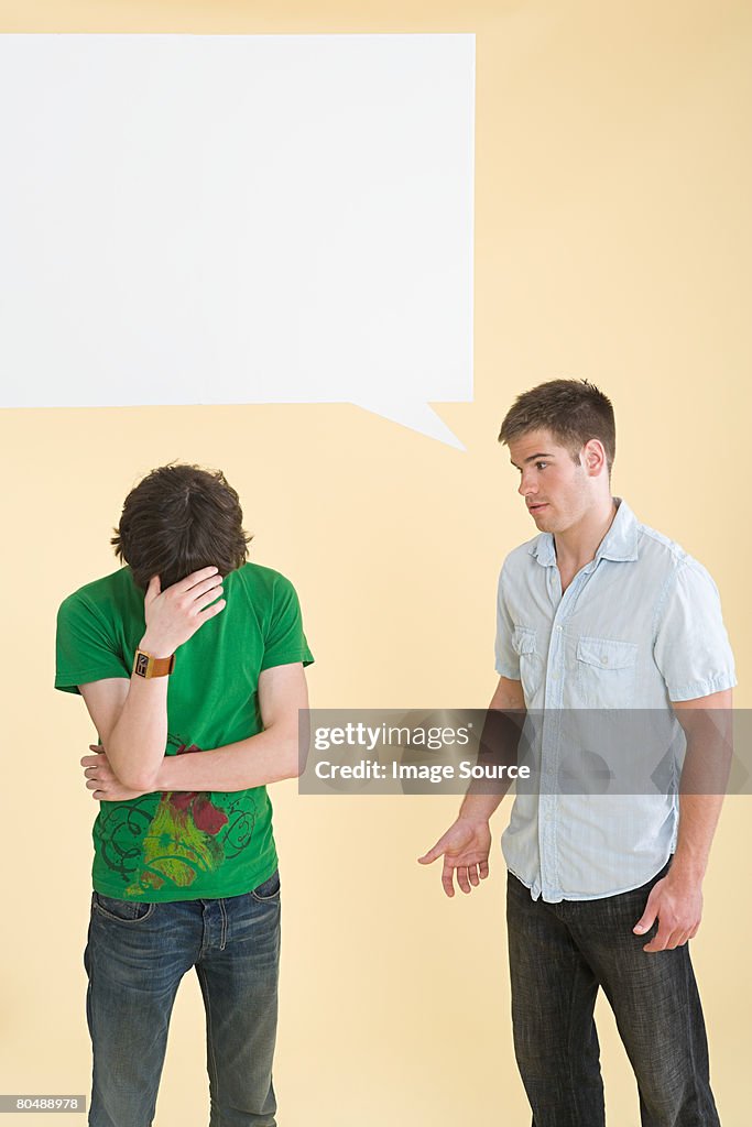 A man talking to another man crying