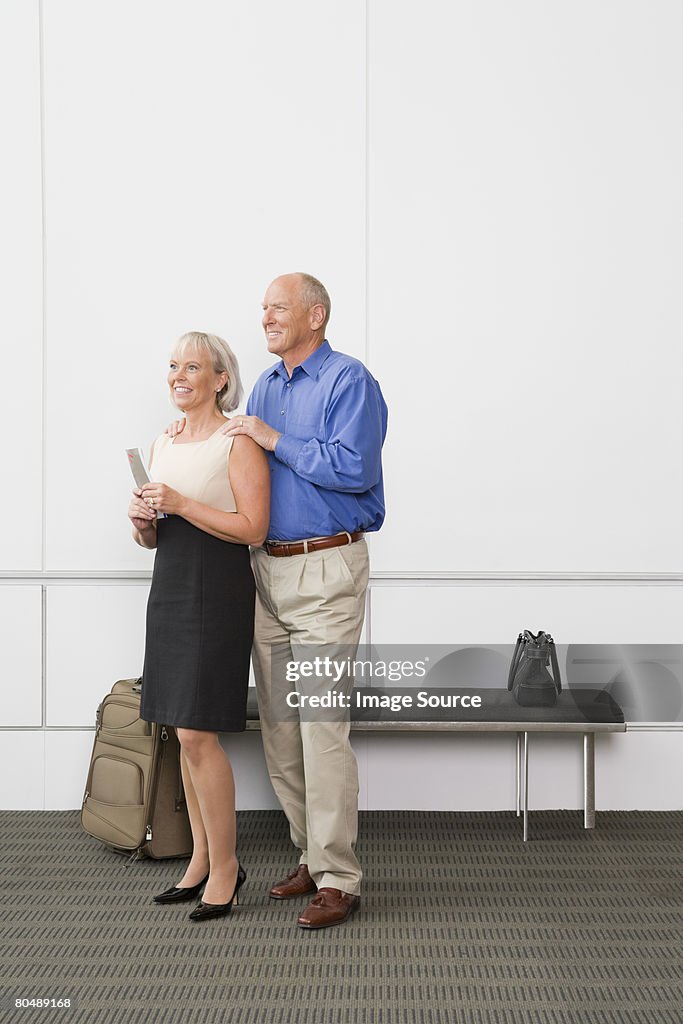 Portrait of a senior couple holding tickets