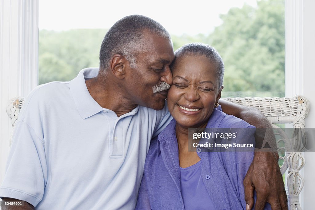 Man kissing wife