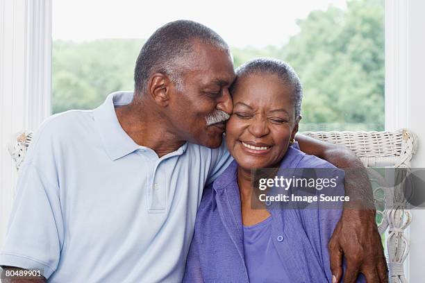 man kissing wife - african american senior man stock pictures, royalty-free photos & images