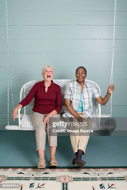 happy women - swing chair stock pictures, royalty-free photos & images