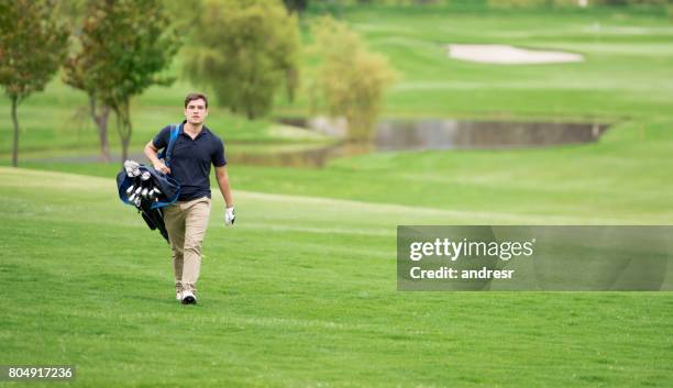 young man playing golf - golf bag stock pictures, royalty-free photos & images