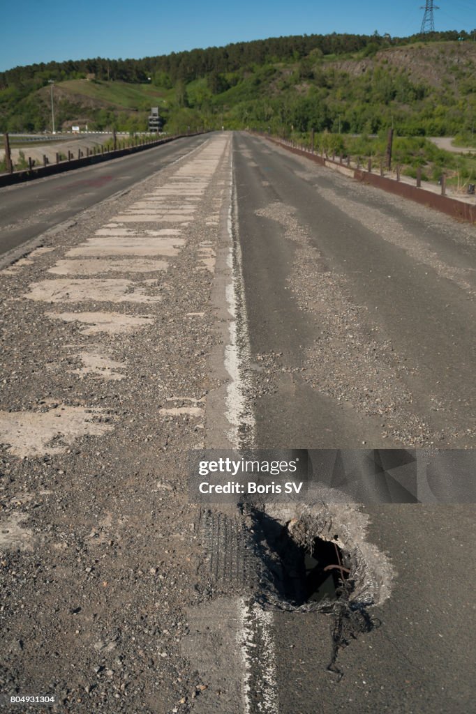 Large pothole on the decommissioned bridge in Kemerovo, Siberia