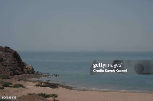 From a remote beach front two oil tankers are seen at a distance in the waters of Strait of Hormuz on May 2, 2017 in Hormuz Island, Iran.