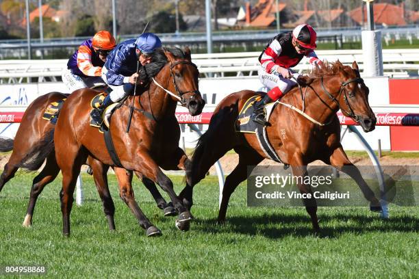 Damien Oliver riding Lone Eagle defeats Brandon Stockdale riding Evil Cry in Race1 during Melbourne Racing at Caulfield Racecourse on July 1, 2017 in...