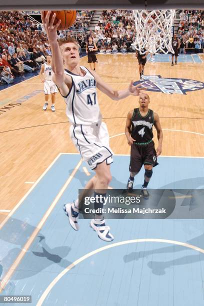 Andrei Kirilenko of the Utah Jazz scores on a breakaway in front of Randy Foye of the Minnesota Timberwolves at EnergySolutions Arena on April 2,...