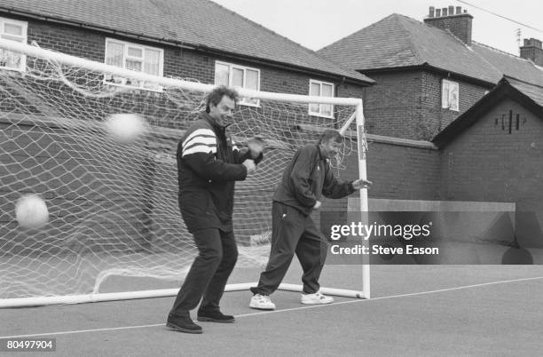 British politician Tony Blair, leader of the Labour Party, wearing a Newcastle United top, playing football with Alex Ferguson of Manchester United,...