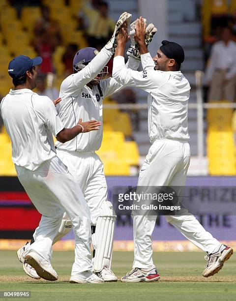 Harbhajan Singh of India celebrates the wicket of Hashim Amla of South Africa for 16 runs during day one of the second test match between India and...