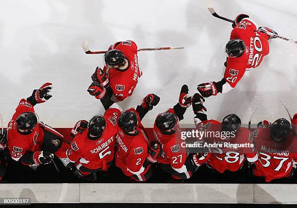 Andrej Meszaros and Antoine Vermette of the Ottawa Senators celebrate a goal against the Buffalo Sabres with teammates at the players' bench at...