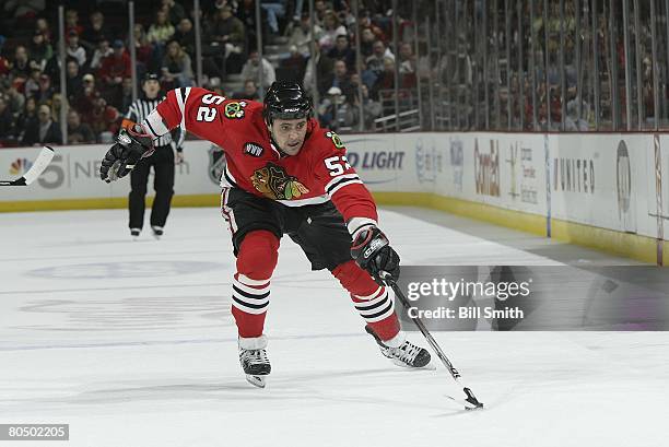 Dustin Byfuglien of the Chicago Blackhawks reaches his stick out to control the puck against the Columbus Blue Jackets on March 30, 2008 at the...