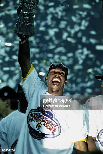 St. Louis Rams wide receiver Isaac Bruce hoists the Vince Lombardi Trophy in triumph following the Rams 23-16 victory over the Tennessee Titans in...