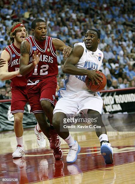 Ty Lawson of the North Carolina Tar Heels drives to the basket against Steven Hill and Marcus Britt of the Arkansas Razorbacks during the 2nd round...