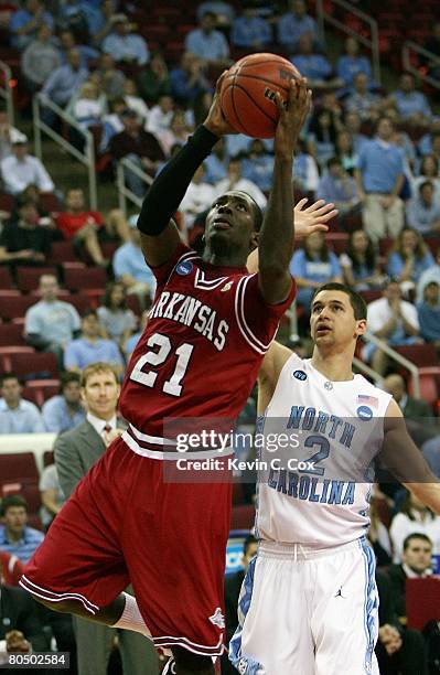Patrick Beverley of the Arkansas Razorbacks goes up for a shot past Marc Campbell of the North Carolina Tar Heels during the 2nd round of the East...