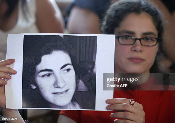 Argentinian Maria Eugenia Sampallo Barragan, daughter of "disappeared" people and stolen herself upon birth, shows pictures of her biological mother...