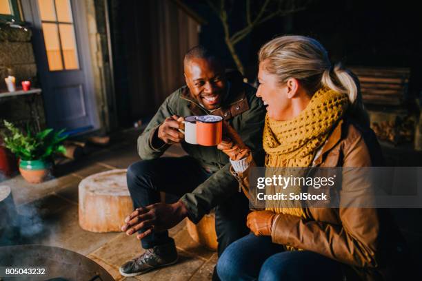 hot chocolate by the fire - couple celebrating stock pictures, royalty-free photos & images