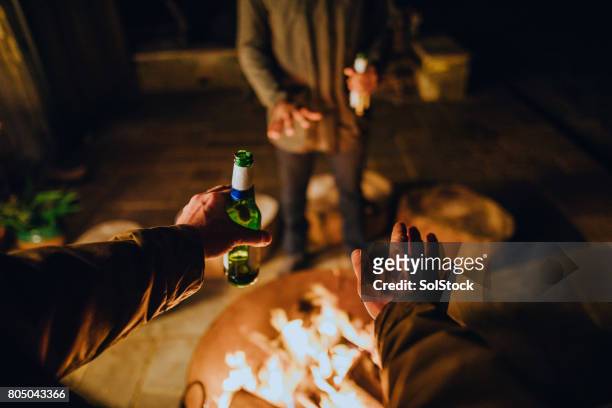 point of view by the fire with friends - fire pit stock pictures, royalty-free photos & images