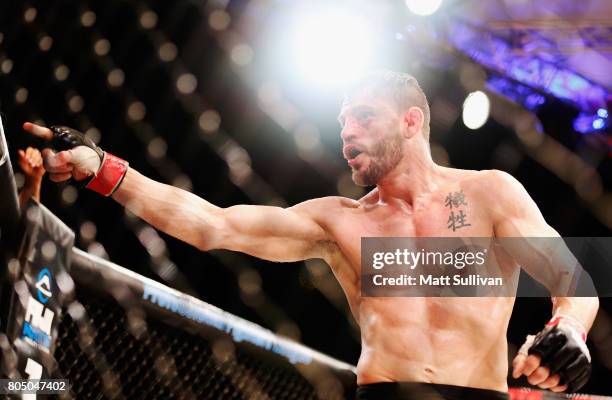 Jon Fitch celebrates defeating Brian Foster in the welterweight main event during Professional Fighters League: Daytona at Daytona International...