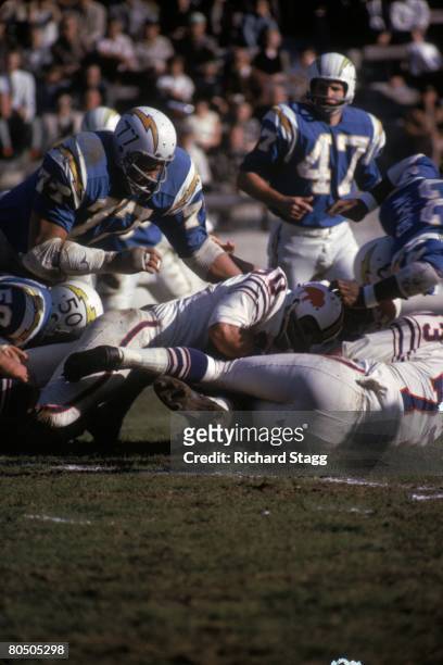 Defensive tackle Ernie Ladd of the San Diego Chargers leaps in to assist on a tackle on fullback Wray Carlton of the Buffalo Bills at Balboa Stadium...