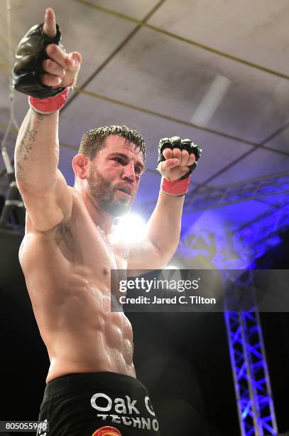 Jon Fitch celebrates after defeating Brian Foster in the welterweight main event during Professional Fighters League: Daytona at Daytona...