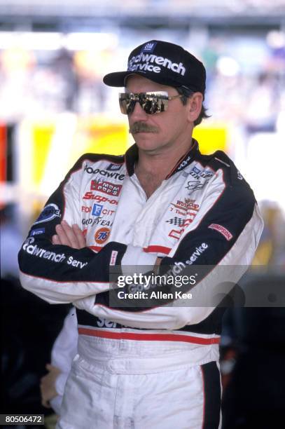 Dale Earnhardt Sr, driver of the Chevy GM Goodwrench Monte Carlo, looks on before a race circa 1990's.