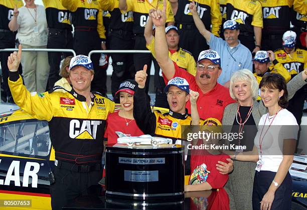 Crew chief Tommy Baldwin, Miss Winston, driver Ward Burton, Ward's son Jeb and wife Tabitha, along with car owners Bill and Gail Davis, celebrate in...