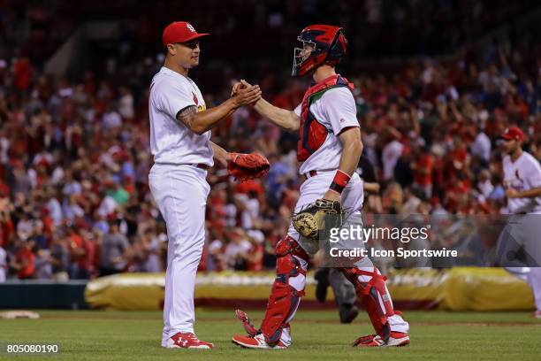 St. Louis Cardinals relief pitcher Sam Tuivailala, left, celebrates with St. Louis Cardinals catcher Eric Fryer, right, on their team's victory at...
