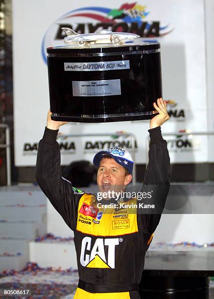 Daytona 500 winner Ward Burton holds up the Harley J. Earl trophy in victory lane