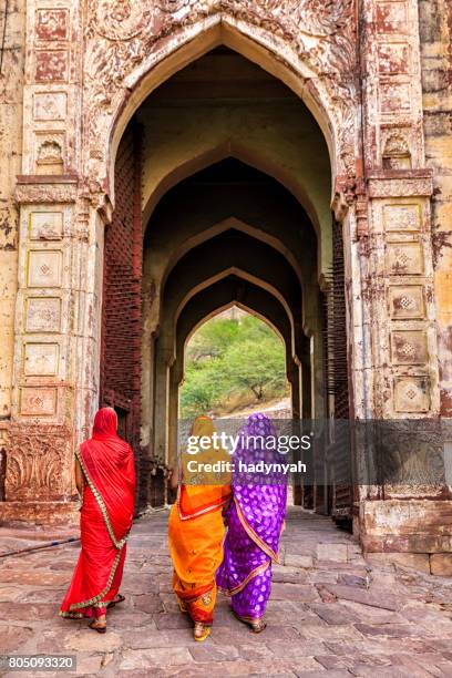 three indian women on the way to mehrangarh fort, india - meherangarh fort stock pictures, royalty-free photos & images