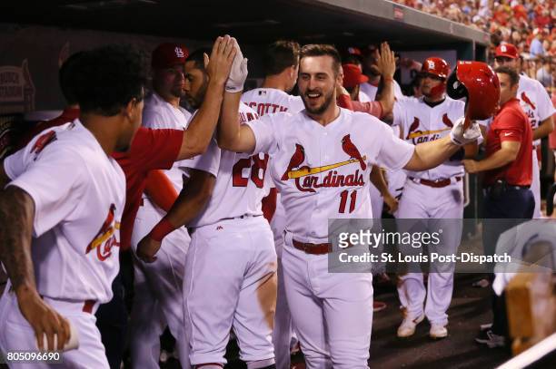 The St. Louis Cardinals' Paul DeJong is congratulated by teammates in the dugout after hitting a two-run home run in the fourth inning against the...