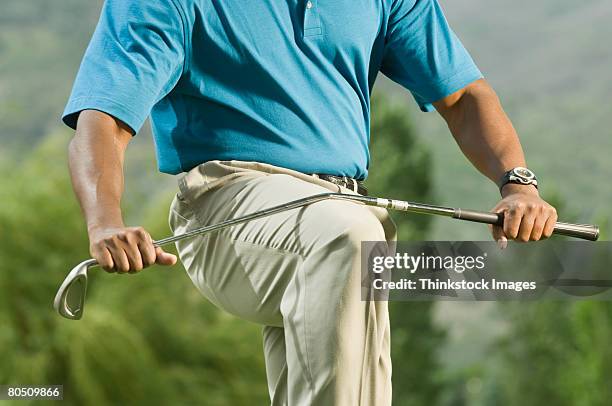 golfer breaking golf club - golf clubs stock pictures, royalty-free photos & images