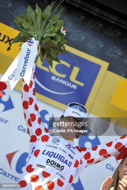 Liquigas's Franco Pellizotti on the podium to collect the polka dot 'King of the Mountains' jersey, after the twentieth stage of the Tour de France...