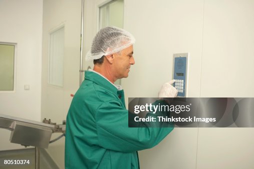 Lab technician using intercom keypad Lab technician using intercom keypad