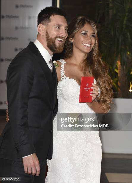 Lionel Messi and Antonela Roccuzzo greet the press after their civil wedding ceremony at the City Center Rosario Hotel & Casino on June 30, 2017 in...