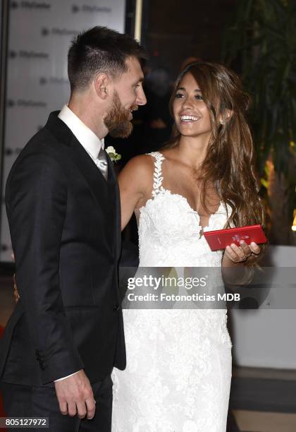 Lionel Messi and Antonela Roccuzzo greet the press after their civil wedding ceremony at the City Center Rosario Hotel & Casino on June 30, 2017 in...