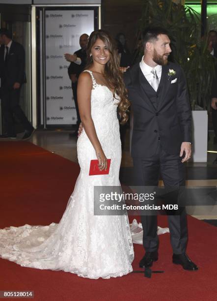 Lionel Messi and Antonela Roccuzzo greet the press after their civil wedding ceremony at the City Center Rosario Hotel & Casino on June 30, 2017 in...