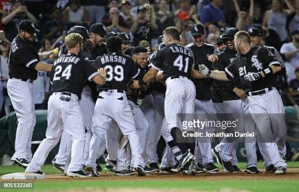 Melky Cabrera of the Chicago White Sox is mobbed by teammates after hitting the game winning, two run, walk-off single in the 9th ininng against the...