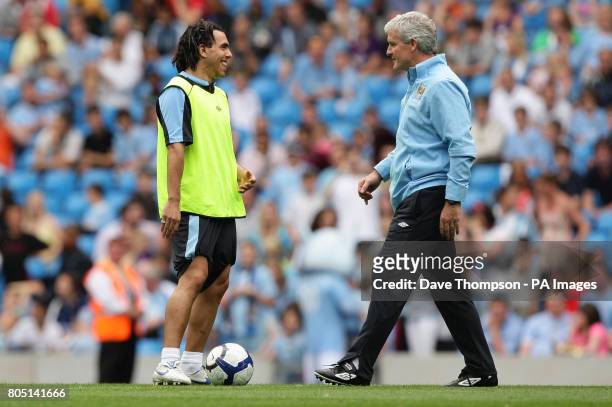 Manchester City manager Mark Hughes and Carlos Tevez during the training session at The City of Manchester Stadium, Manchester.