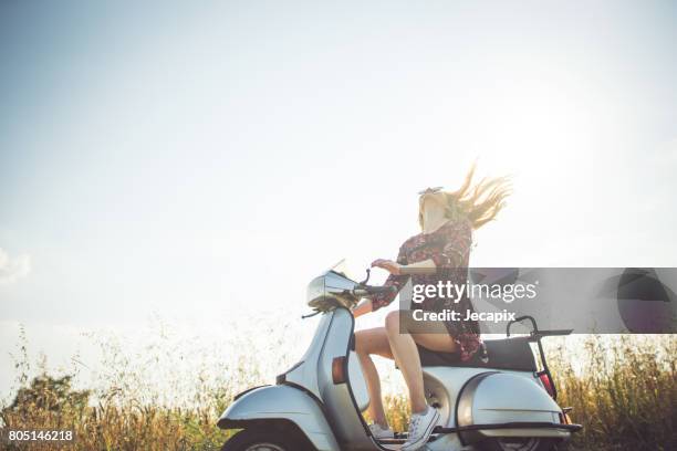 enjoying the summer on motorbike - woman riding scooter stock pictures, royalty-free photos & images