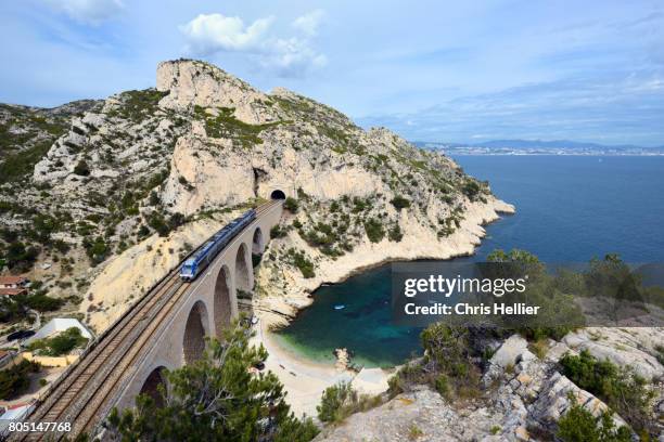 train crosses viaduct on the côte bleue or blue coast west of marseille - train france stock pictures, royalty-free photos & images