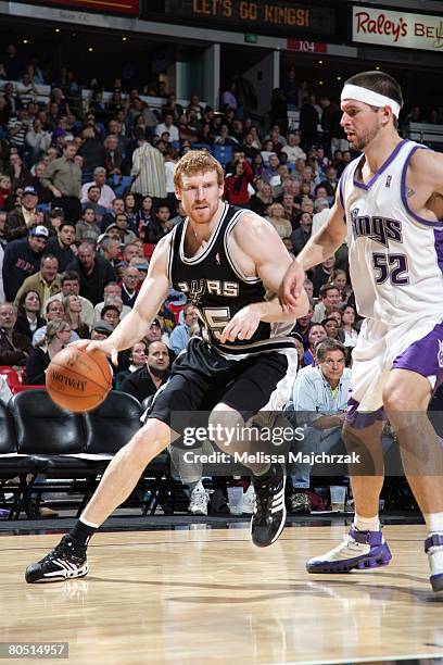 Matt Bonner of the San Antonio Spurs dribbles against Brad Miller of the Sacramento Kings during the game at ARCO Arena on November 26, 2007 in...