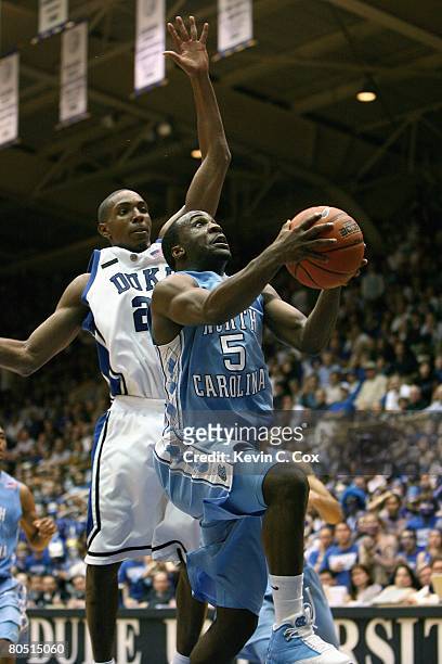 Ty Lawson of the North Carolina Tar Heels drives up for basket against DeMarcus Nelson of the Duke Blue Devils at Cameron Indoor Stadium on March 8,...