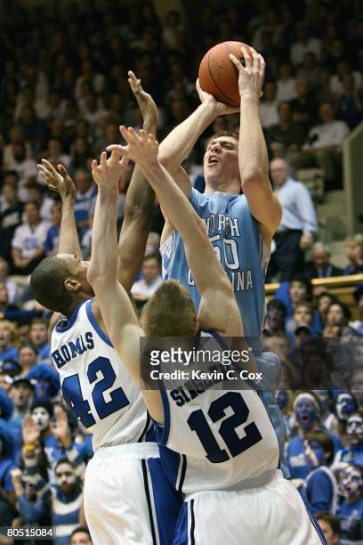 Tyler Hansbrough of the North Carolina Tar Heels makes a jumpshot against Lance Thomas and Kyle Singler of the Duke Blue Devils during the game at...
