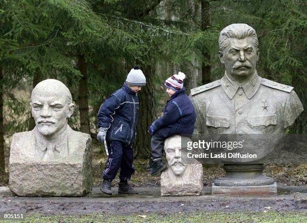 Children play next to the busts of former dictators Vladimir Lenin and Josef Stalin at the Soviet Sculpture Garden, dubbed "Stalin World," in the...